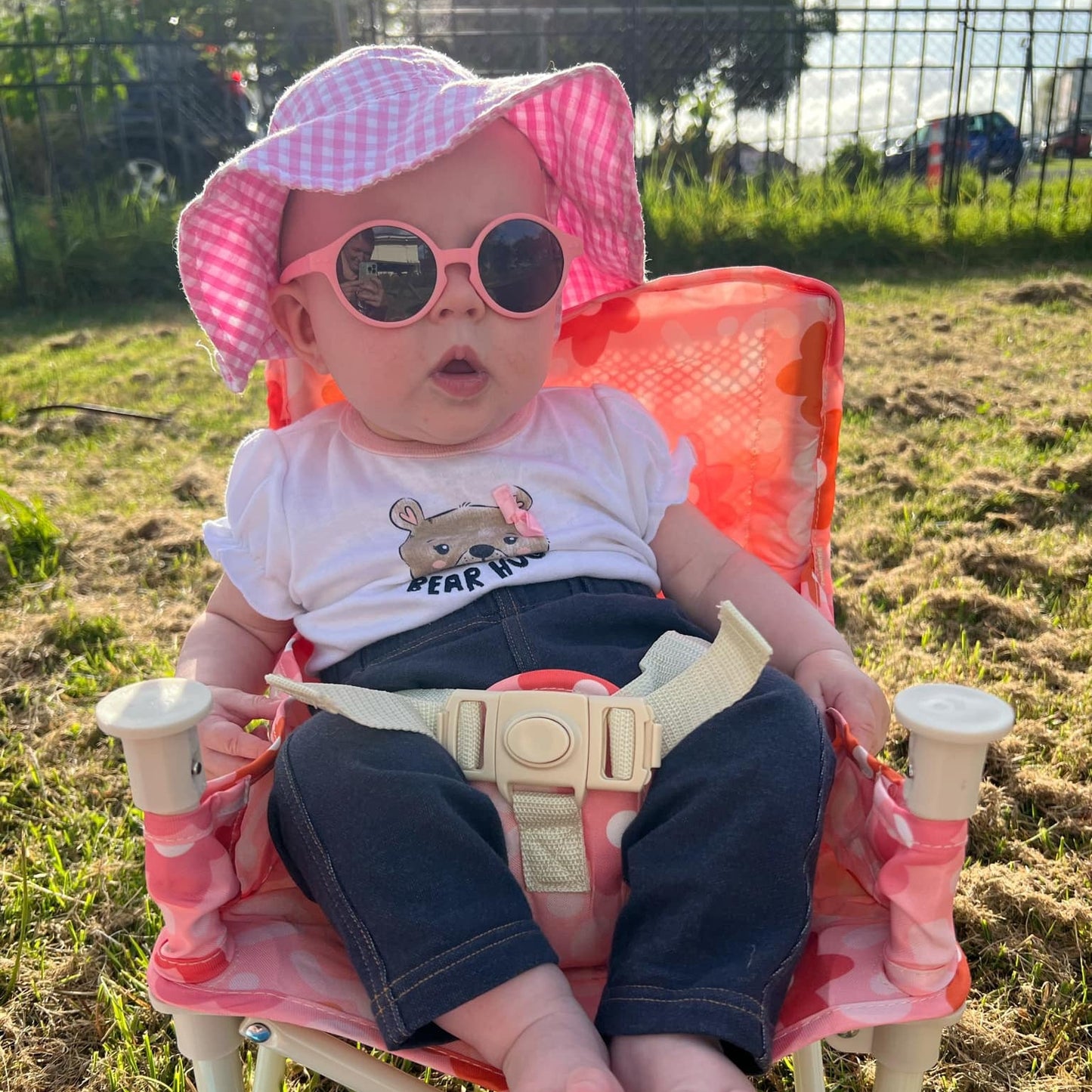 Candy Floss Baby Sunglasses with detachable rubber head strap. Round Frames. For babies 6M-3Y old. Image depicts baby girl wearing hot pink sunglasses.